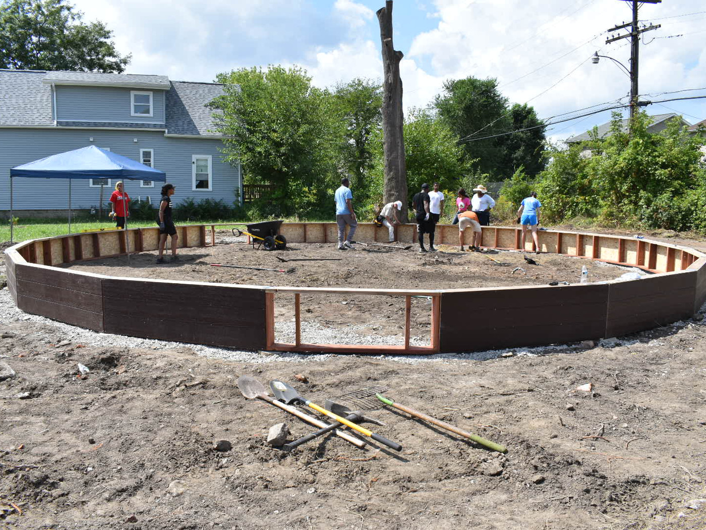 Neighbors framing out the base of a new community garden bed